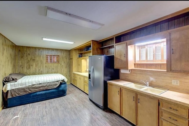kitchen with light countertops, open shelves, wood walls, and stainless steel fridge with ice dispenser