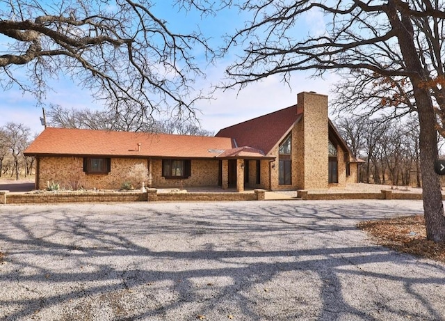view of front of house featuring driveway and a chimney
