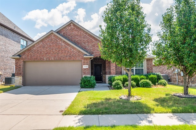 view of front of home with a garage, central AC unit, and a front lawn