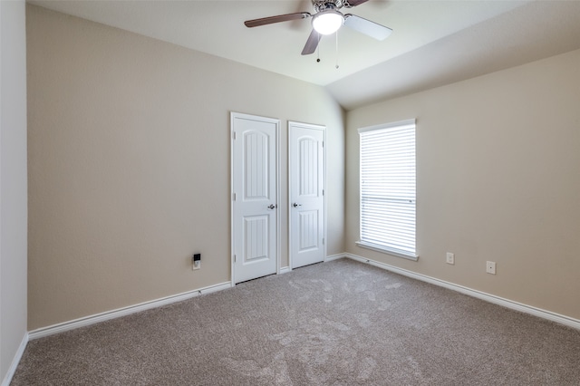 unfurnished bedroom featuring vaulted ceiling, ceiling fan, and carpet floors