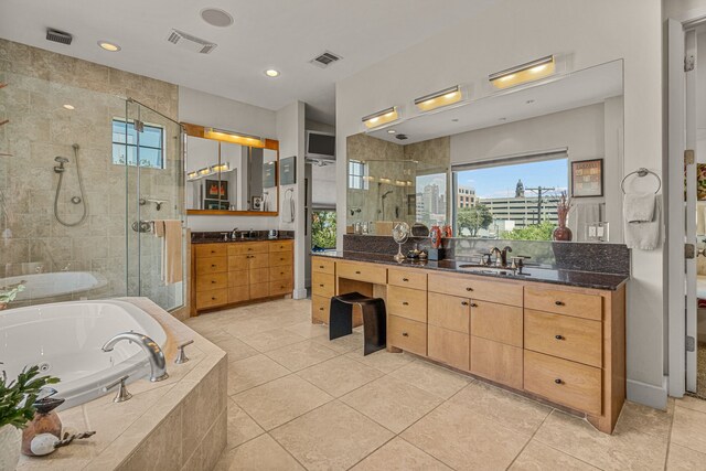 bathroom with a wealth of natural light, vanity, tile patterned floors, and separate shower and tub