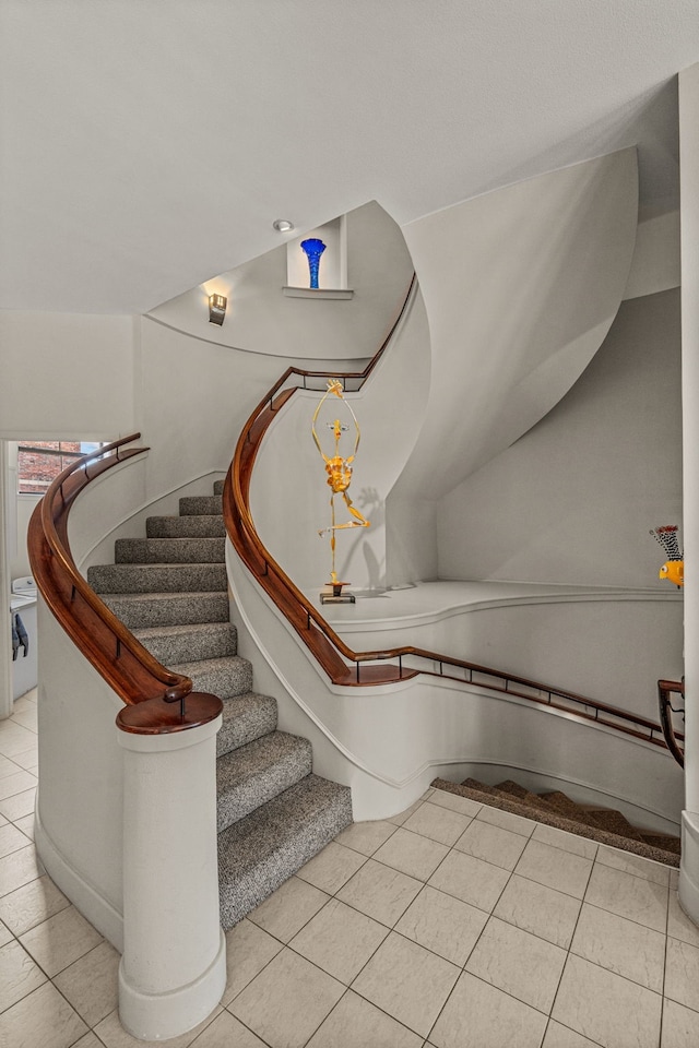 staircase with light tile patterned floors