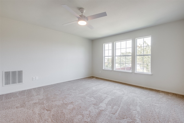 unfurnished room with carpet and ceiling fan