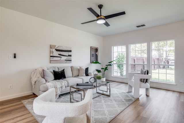 living room featuring ceiling fan and light wood-type flooring