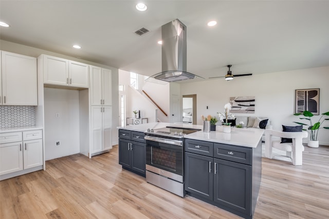 kitchen with stainless steel electric range, ceiling fan, white cabinets, light wood-type flooring, and gray cabinetry