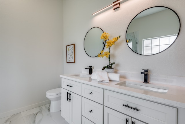 bathroom featuring dual vanity, tile patterned flooring, and toilet