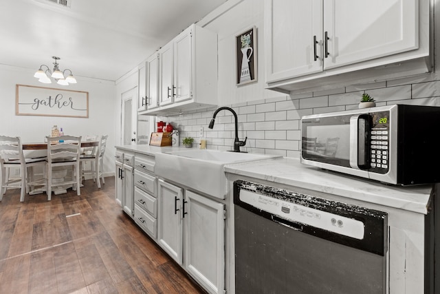 kitchen with white cabinets, backsplash, dark hardwood / wood-style flooring, stainless steel appliances, and sink