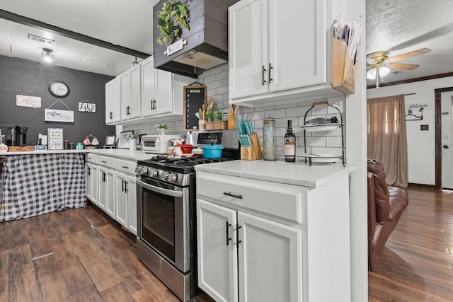 kitchen featuring custom range hood, backsplash, dark wood-type flooring, ceiling fan, and stainless steel gas stove