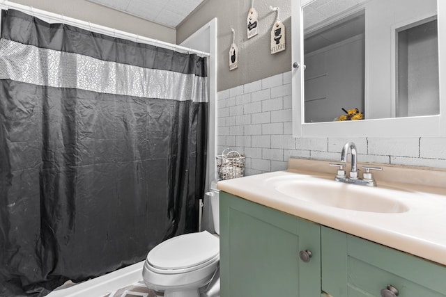 bathroom featuring tile walls, tasteful backsplash, toilet, and vanity