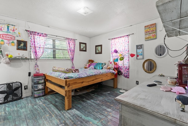 bedroom with wood-type flooring and a textured ceiling