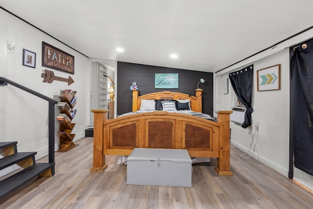 bedroom featuring light wood-type flooring and vaulted ceiling