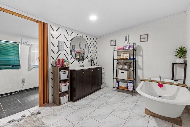 bathroom featuring a washtub, tile patterned floors, crown molding, and vanity