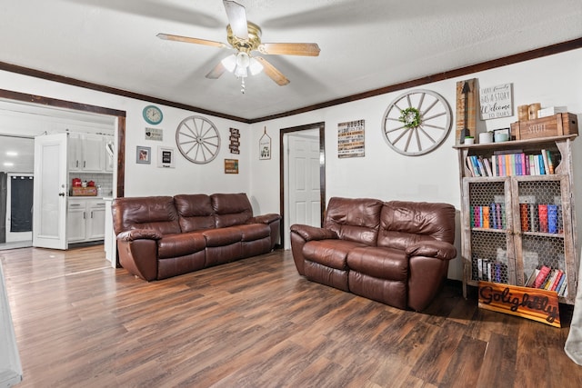 living room featuring a textured ceiling, hardwood / wood-style flooring, crown molding, and ceiling fan