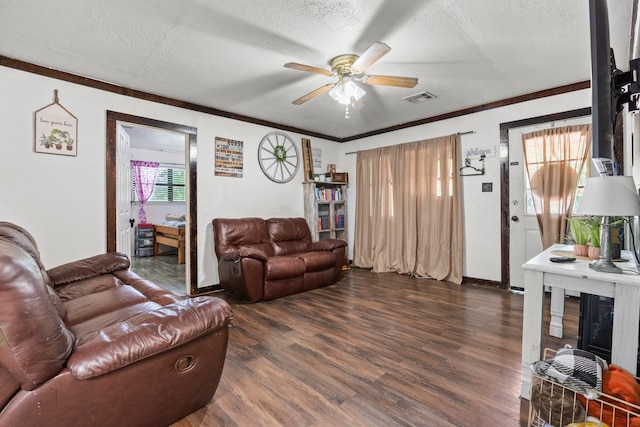 living room featuring dark hardwood / wood-style floors, a textured ceiling, and ceiling fan