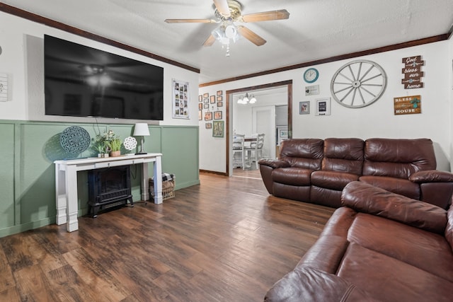 living room featuring dark hardwood / wood-style floors, a textured ceiling, crown molding, and ceiling fan