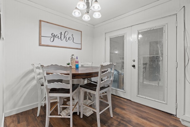 dining area with a chandelier, dark hardwood / wood-style floors, and french doors