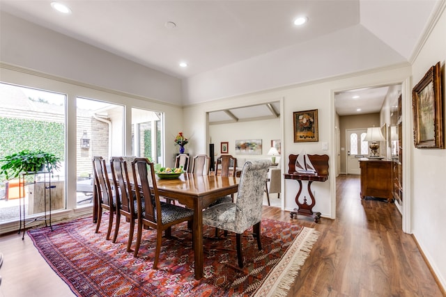 dining room featuring dark hardwood / wood-style flooring and lofted ceiling