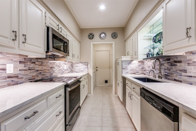 kitchen featuring white cabinets, stainless steel appliances, sink, and tasteful backsplash