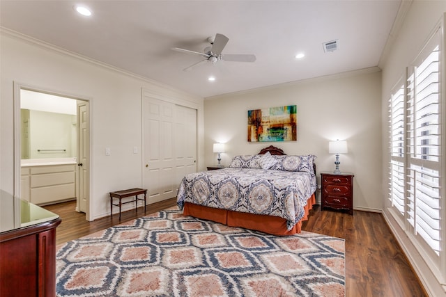 bedroom with ornamental molding, ensuite bathroom, ceiling fan, dark wood-type flooring, and a closet