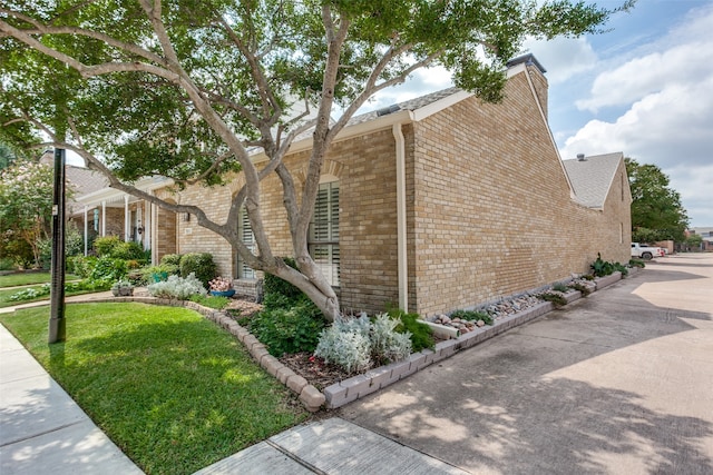 view of side of property with a lawn