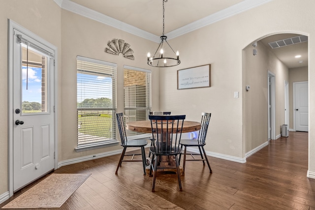 dining area featuring a chandelier, dark hardwood / wood-style flooring, and ornamental molding