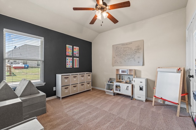 rec room with lofted ceiling, light colored carpet, and ceiling fan