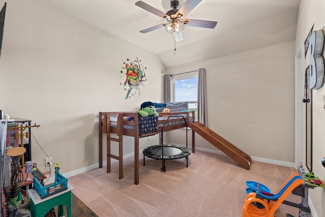 carpeted dining space featuring lofted ceiling and ceiling fan