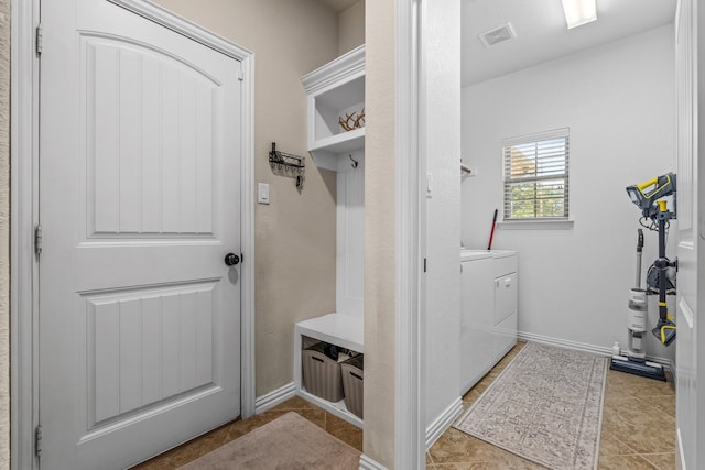 mudroom featuring light tile patterned flooring and washer / dryer