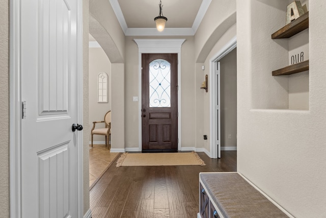 foyer featuring dark hardwood / wood-style flooring and crown molding