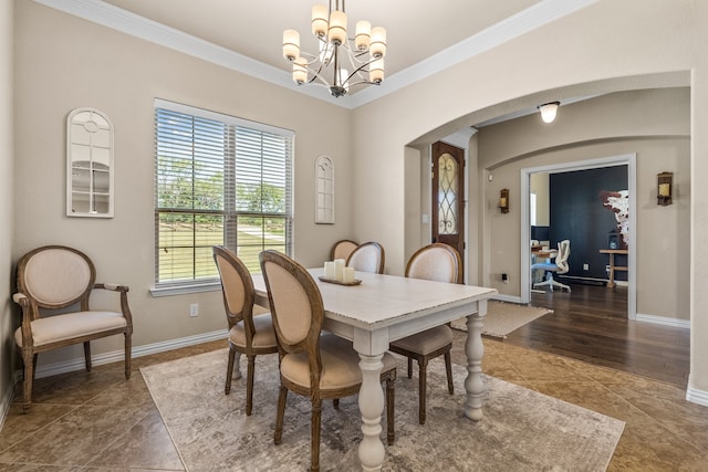 dining room featuring a chandelier, crown molding, and dark tile patterned flooring