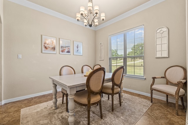 dining area with dark tile patterned floors, ornamental molding, and an inviting chandelier