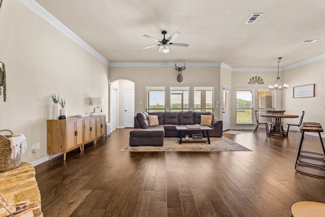 living room with a textured ceiling, dark hardwood / wood-style flooring, ceiling fan with notable chandelier, and crown molding