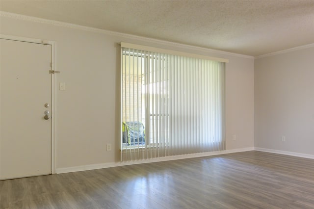 unfurnished room with a textured ceiling, hardwood / wood-style flooring, and crown molding