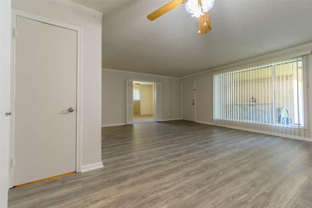 unfurnished room featuring a textured ceiling, hardwood / wood-style flooring, crown molding, and ceiling fan