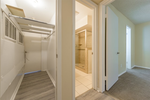 corridor featuring carpet and a textured ceiling