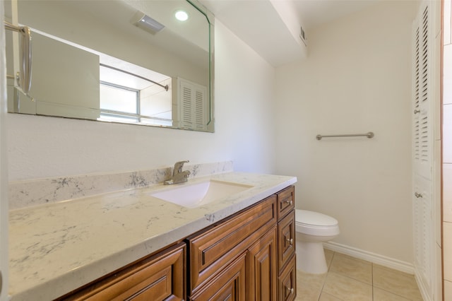 bathroom featuring tile patterned floors, vanity, and toilet