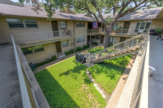 view of home's community with a lawn