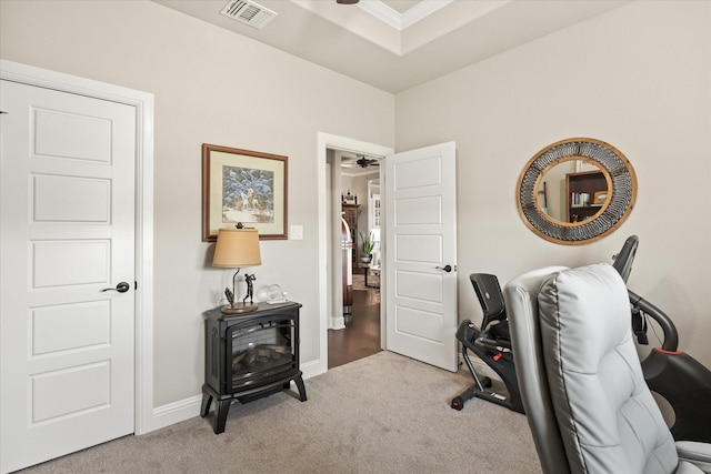 office featuring a raised ceiling, crown molding, light carpet, and ceiling fan