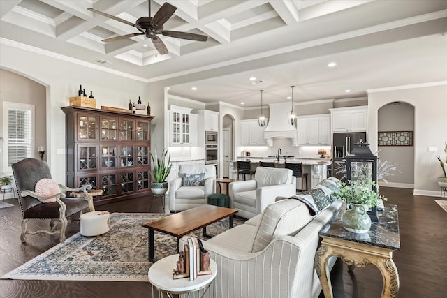 living room with coffered ceiling, dark hardwood / wood-style floors, sink, and beamed ceiling