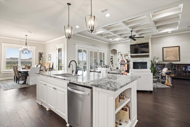 kitchen with dishwashing machine, white cabinets, sink, dark hardwood / wood-style floors, and a stone fireplace