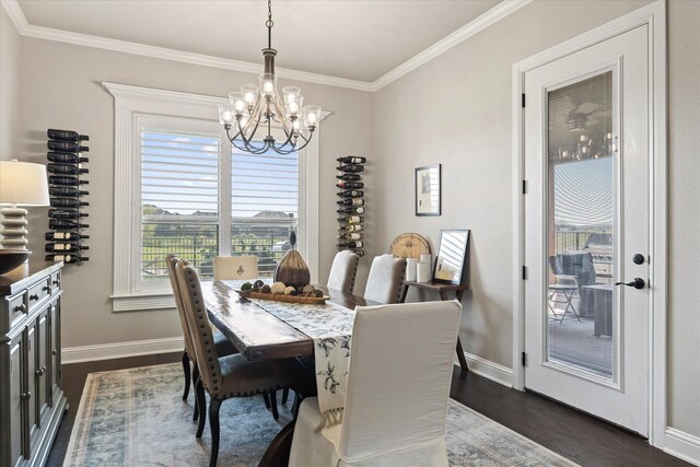 dining room featuring dark hardwood / wood-style flooring, crown molding, and a chandelier