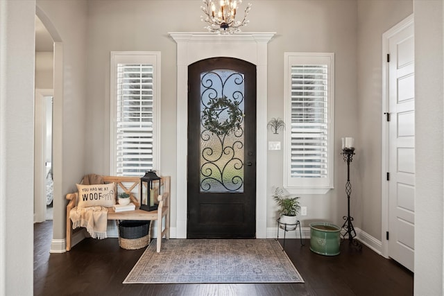 foyer with a chandelier and wood-type flooring