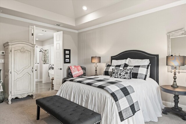 bedroom with carpet floors, crown molding, and a tray ceiling