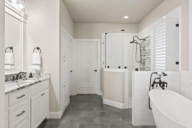 bathroom with vanity, tile patterned flooring, independent shower and bath, and tile walls