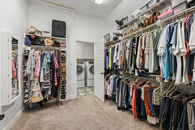 walk in closet with separate washer and dryer and carpet floors