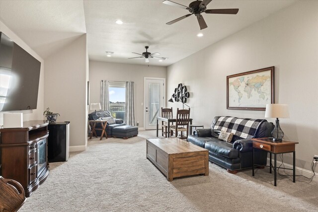 carpeted living room featuring ceiling fan