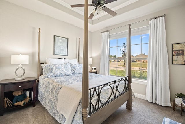 bedroom with a tray ceiling, ornamental molding, carpet floors, and ceiling fan