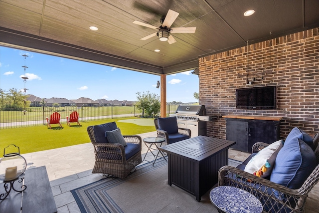 view of patio featuring a grill, exterior kitchen, an outdoor living space, and ceiling fan