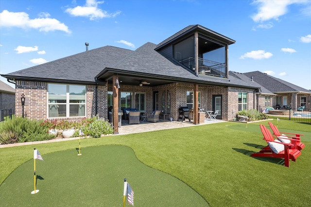 rear view of house with a patio, a balcony, and ceiling fan