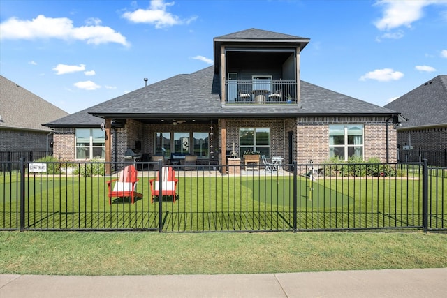 view of front of property featuring a balcony and a front yard